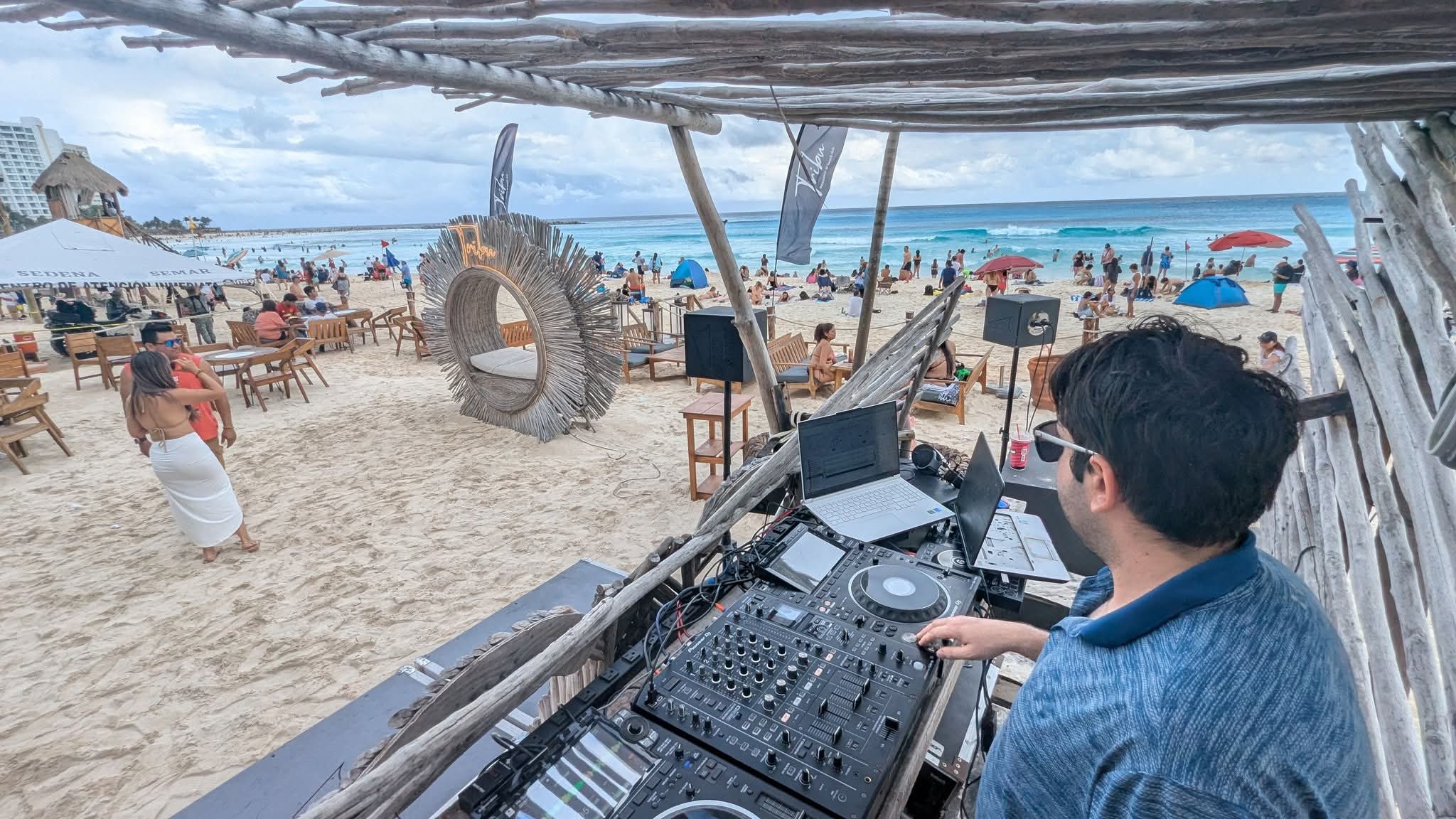 DJ NVision Nick McPherson DJing on the beach at Tribu lounge in Cancun, Mexico